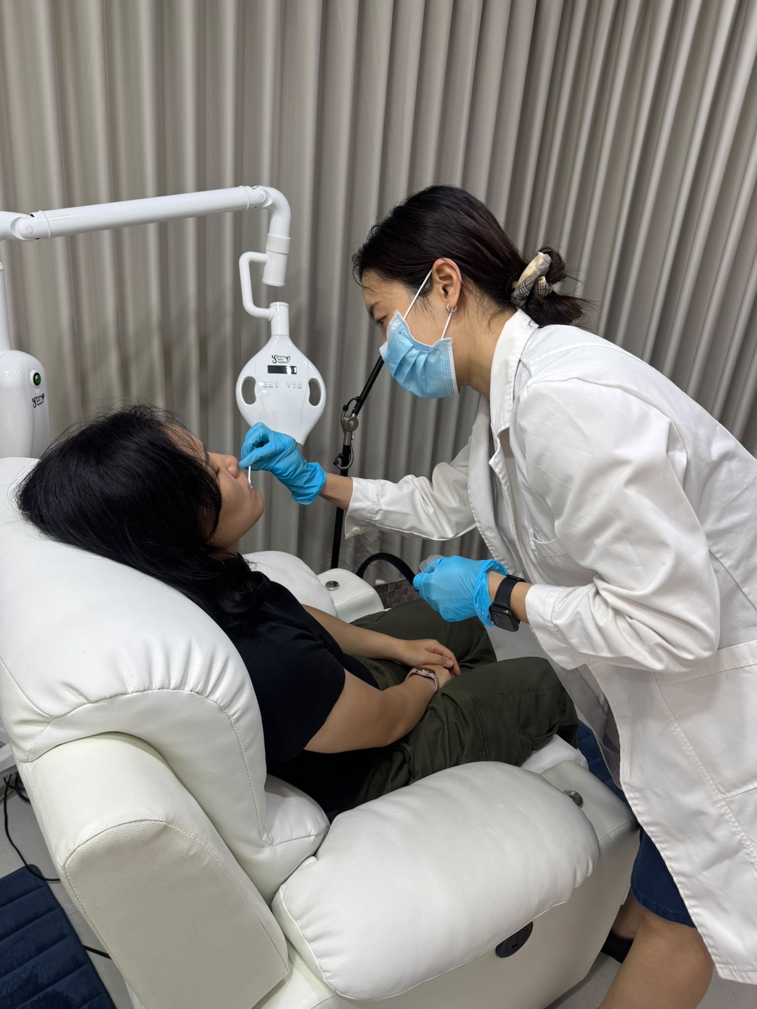 Staff applying lip balm before the whitening service